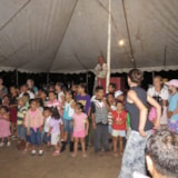 Volunteers lead a children’s gathering under a tent in Honduras