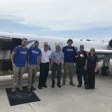 Judah 1 mission team and crew with jet on the airport ramp