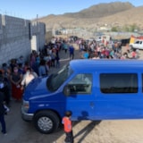 Families line up for a school community event in Juárez, Mexico