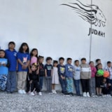 Children line up outside the Juárez school building