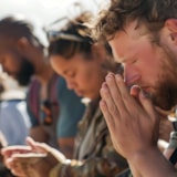 Missionary team prays together at the start of service work