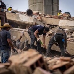 Relief workers dig through collapsed buildings in Venezuela