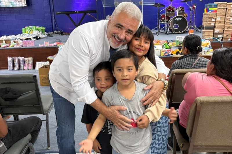 Volunteers greet families during an aid outreach in Juárez